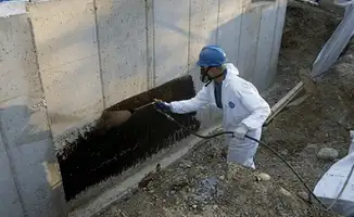 Professional waterproofing the exterior walls of the basement in Boston, MA