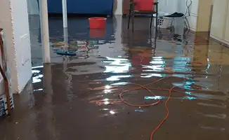 Basement with boiler, cabinets and washing machine completely flooded in Boston, MA